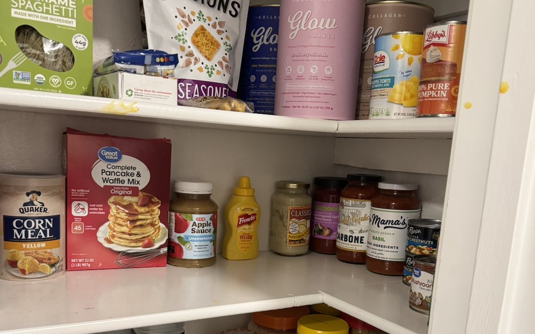 Organized pantry with canned goods, snacks, and baking supplies grouped by category