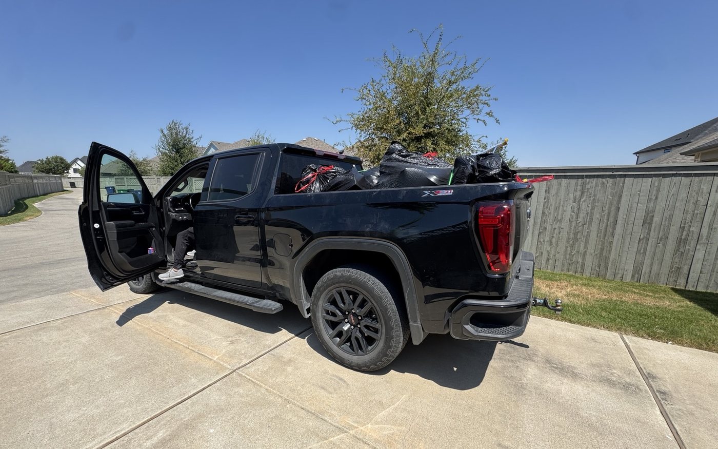 Pickup truck loaded with bags of junk and donations from a garage cleanout